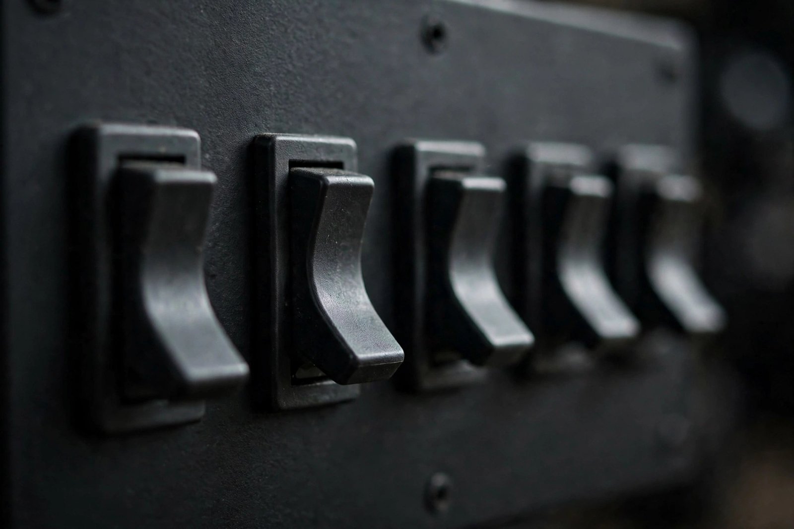 Close-up of toggle switches flipped to the off position, illustrating how to disable every plugin when hunting a wordpress plugin conflict